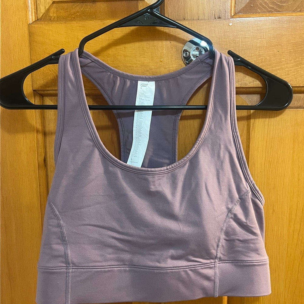 Fabletics. On-The-Go Medium Impact Sports Bra in a Dusty purple shade